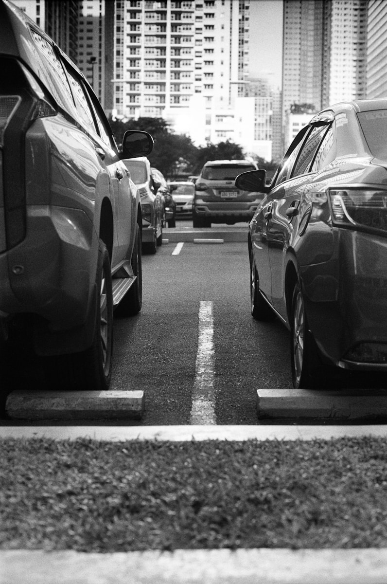 grayscale photo of cars on road