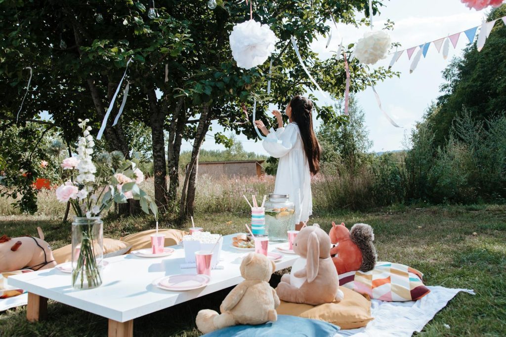 Child's outdoor birthday party with picnic setup and decorations.