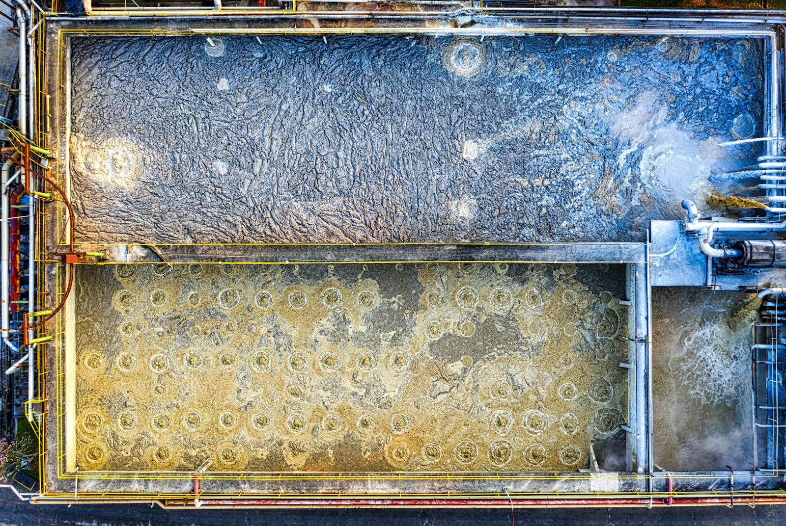 Aerial shot of an industrial water treatment plant with visible aeration tanks and machinery in Indonesia.